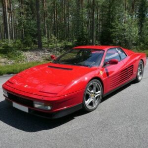 A 1990 Ferrari Testarossa on a forest road, perfect for "car engine sound library" enthusiasts on Sonniss.