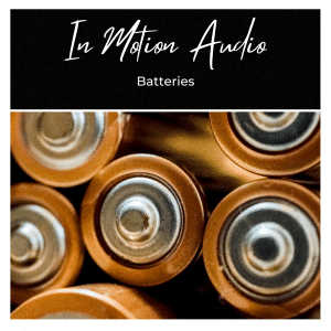 Several AA battery tops grouped closely together, with "In Motion Audio" and "Batteries" text above on a black background.