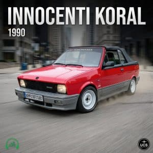 A red and gray 1990 Innocenti Koral convertible with white wheels and black soft top drives in a city. "Yokohama" on windshield.