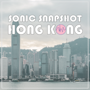 Hong Kong skyline with tall buildings, green hills in the background, cloudy sky. “SONIC SNAPSHOT HONG KONG” text overlays image.