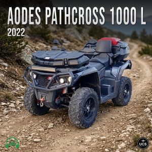 A black 2022 AODES Pathcross 1000 L ATV parked on a rocky dirt trail with mountains and greenery in the background.