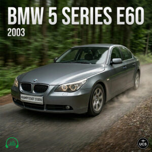 Grey BMW 5 Series E60 2003 executive car speeds along a forest gravel road.