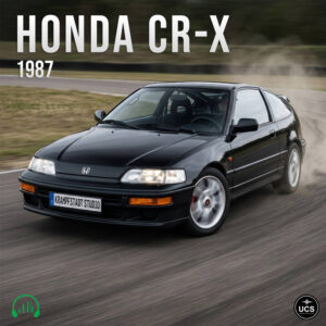 Black 1987 Honda CR-X hatchback drives on a race track with dust rising from the rear tires.