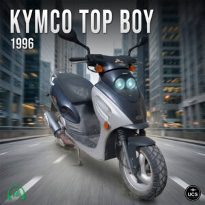 Two-toned 1996 Kymco Top Boy scooter with dual headlamps driving on a city street.