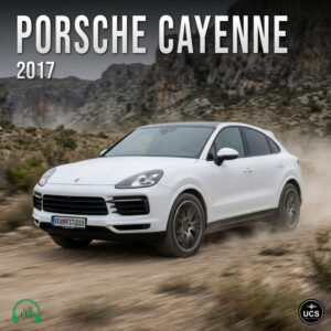 White 2017 Porsche Cayenne full-size crossover SUV drives on a dirt road before rocky hills.