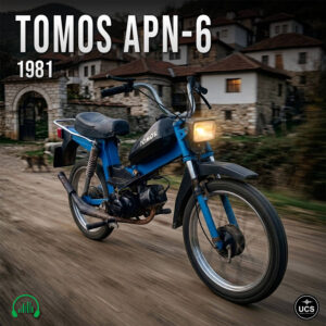Blue Tomos APN-6 1981 moped motorbike rides along a road past stone houses.