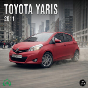 Red 2011 Toyota Yaris subcompact supermini car drives along a city street.