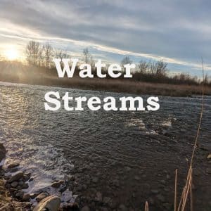 A sound effects library image on Sonniss: River flowing over rocks at sunset for water streams sfx and nature ambience needs.